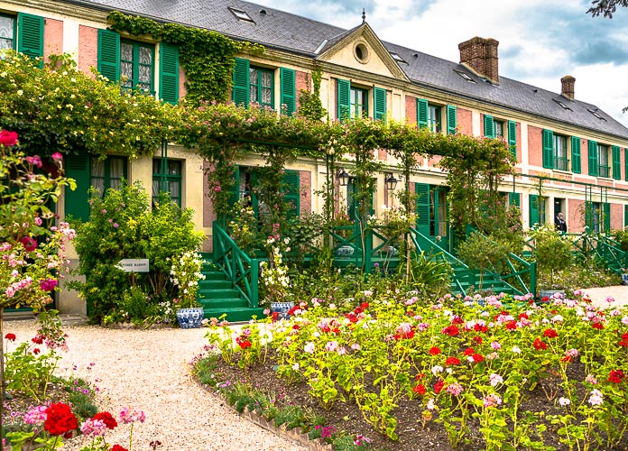 Monet's pink house with its green shutters and geranium beds